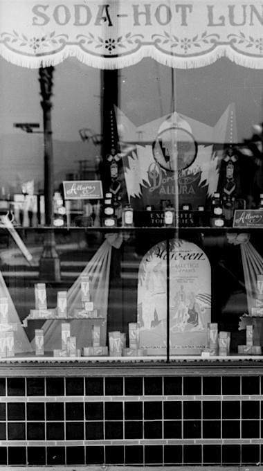 1929 Drug store window with a display of Doraldina Allura