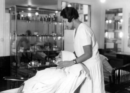 1928 Client undergoing a facial treatment