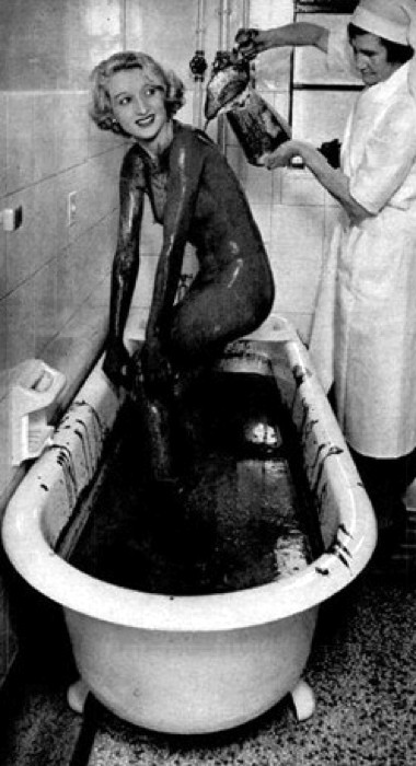 1937 Woman taking a mud bath