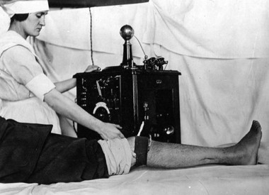 Nurse administering a diathermy treatment for the knee