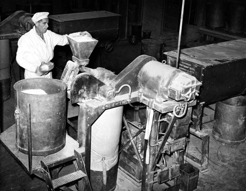 Worker feeding a micropulverisers from a large can
