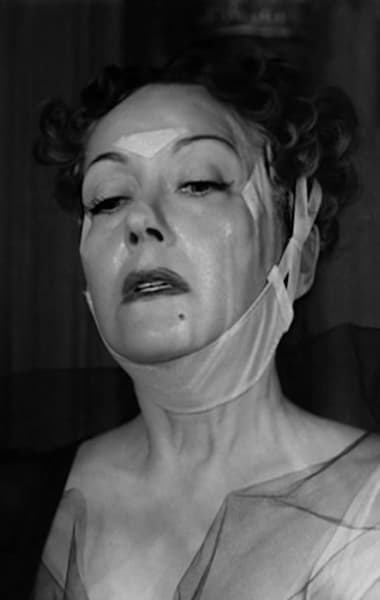 Norma Desmond getting ready for bed with tapes and a chinstrap